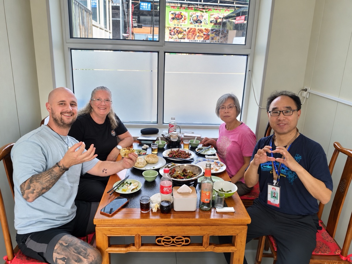 Travelers sharing a Chinese lunch with their driver
