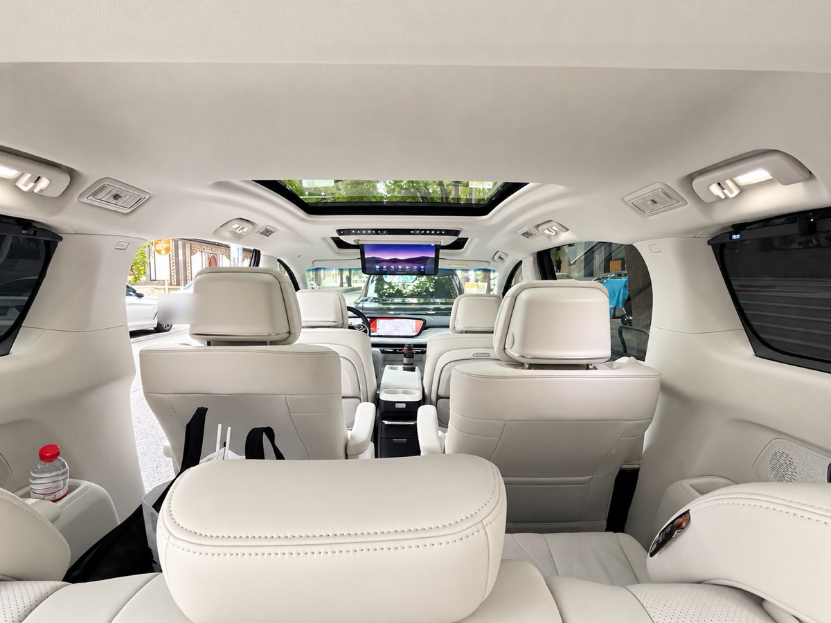 The bright van cabin seen from the back row
